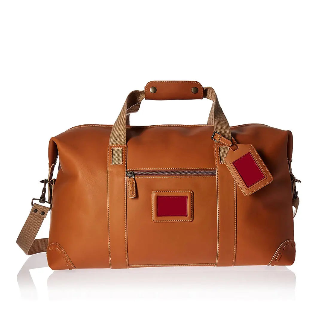 Tan PU leather travel trunk duffel bag with crossbody strap, top handles, and side luggage tag, perfect for travel.