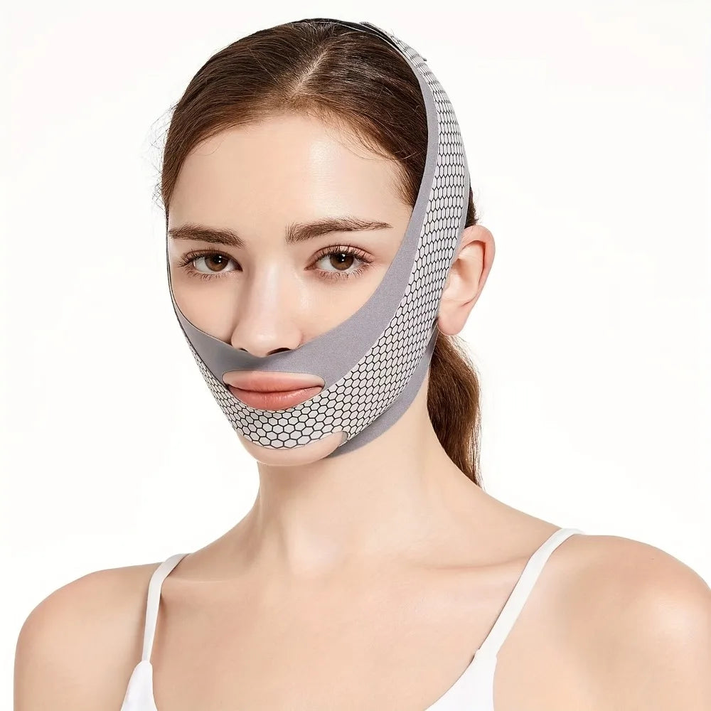 A woman wears a grey, breathable V-line face slimming bandage with a white honeycomb pattern over her chin and jaw.