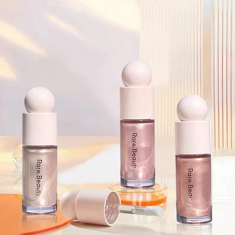 Rare Beauty waterproof liquid highlighter bottles with shimmer finish, applicator wand, and smooth, radiant texture.
