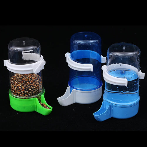 Plastic automatic bird feeder and water dispenser, blue clear cup with white base and handle.