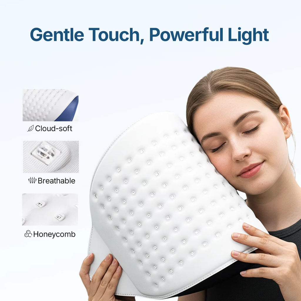 Woman resting her cheek on a soft, white, flexible LED light therapy mask with a honeycomb-patterned interior.