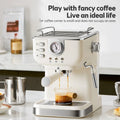 Cream-colored compact espresso machine with built-in pressure gauge and chrome accents brewing coffee.