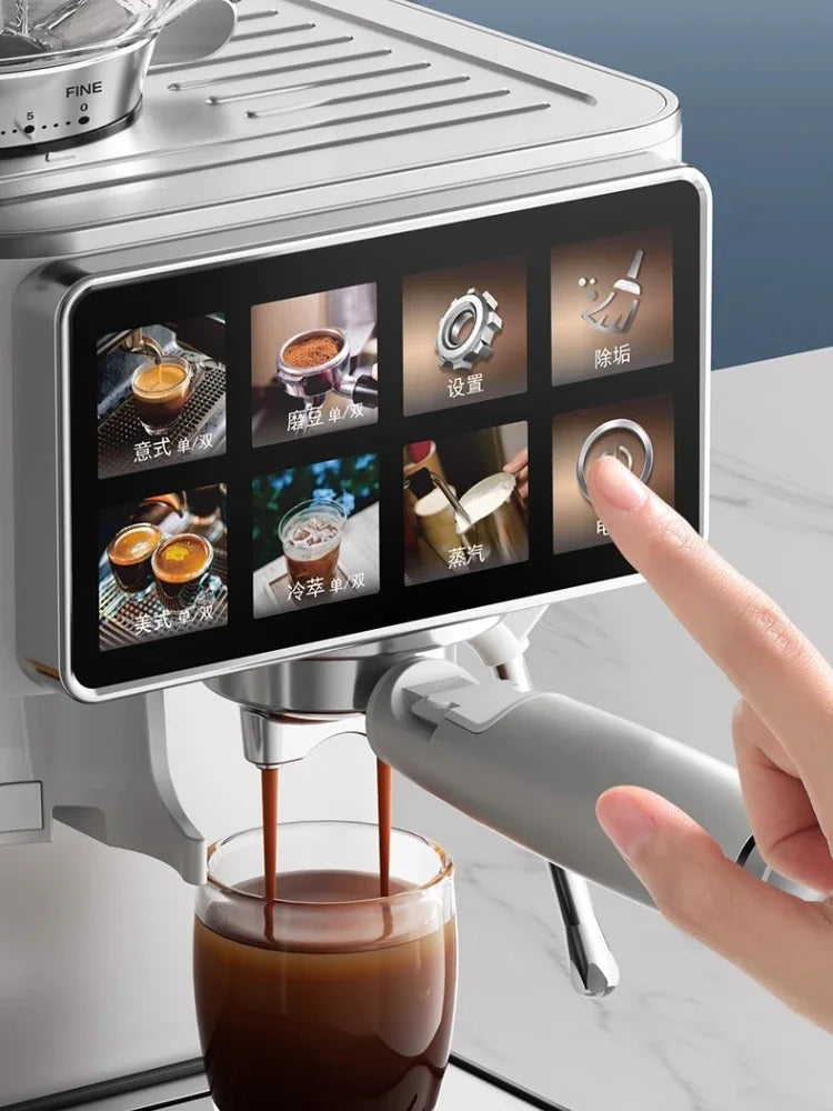 Silver espresso machine with digital touchscreen, brewing coffee into a glass cup with a modern sleek design.
