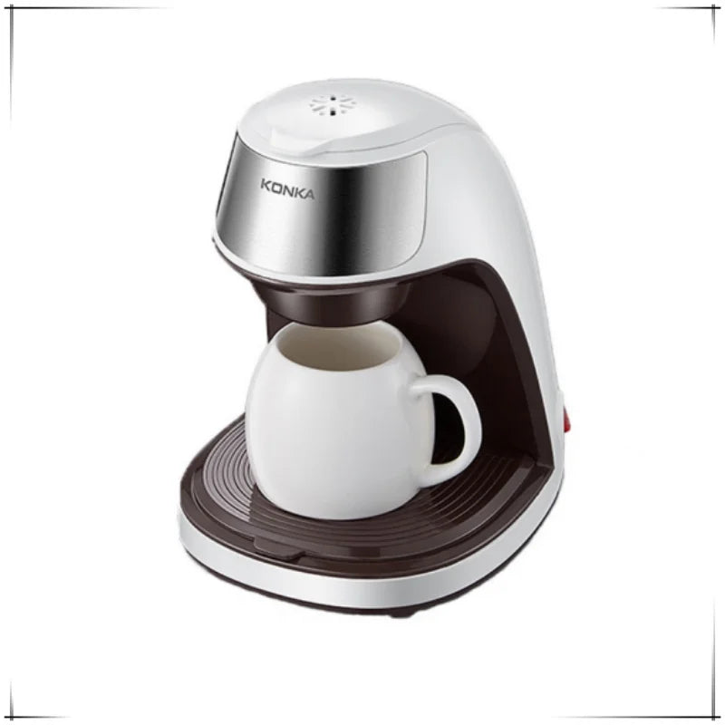 Konka single-serve white and brown plastic coffee maker with a matching white ceramic mug.