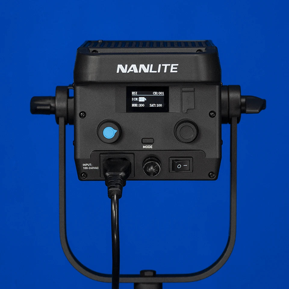 Black LED studio light with digital display, adjustment knobs, and U-shaped mounting yoke on a blue background.
