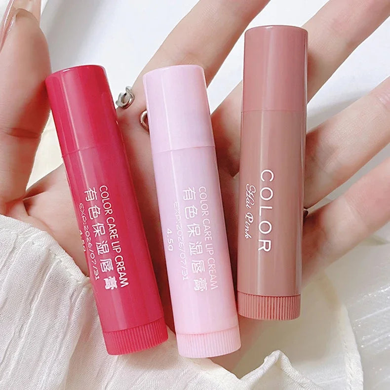 Three moisturizing tinted lip balms in red, pink, and nude shades for dry, anti-aging lip care and hydration.