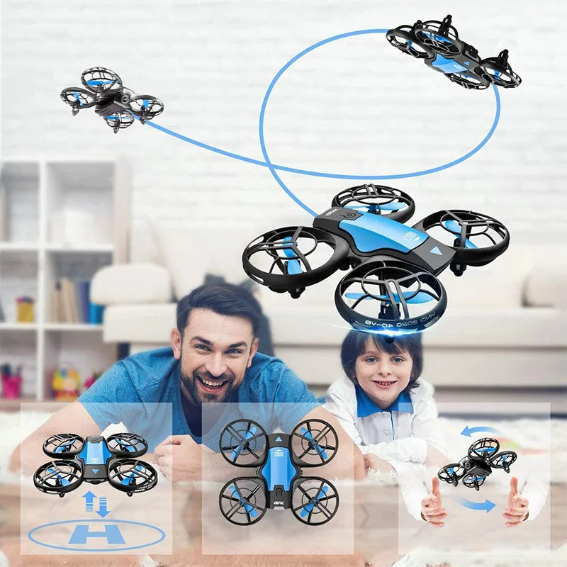 Blue and black mini quadcopter drone with protective rotor guards, flying indoors for recreational use.