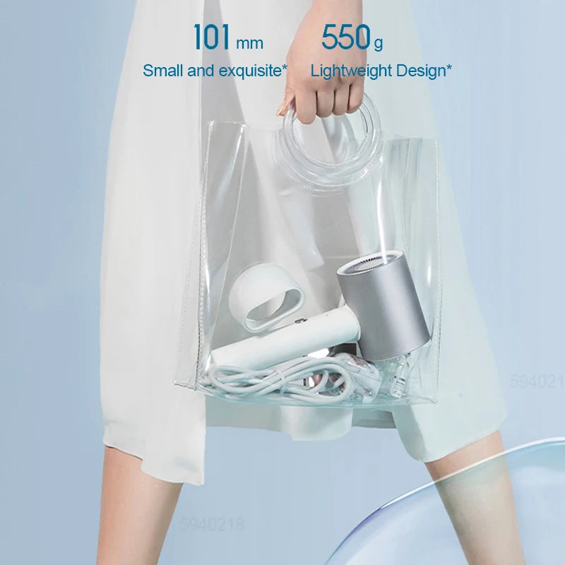 MIJIA H500 ionic hair dryer: lightweight 550g, compact design with magnetic nozzle attachment in a clear carry bag.