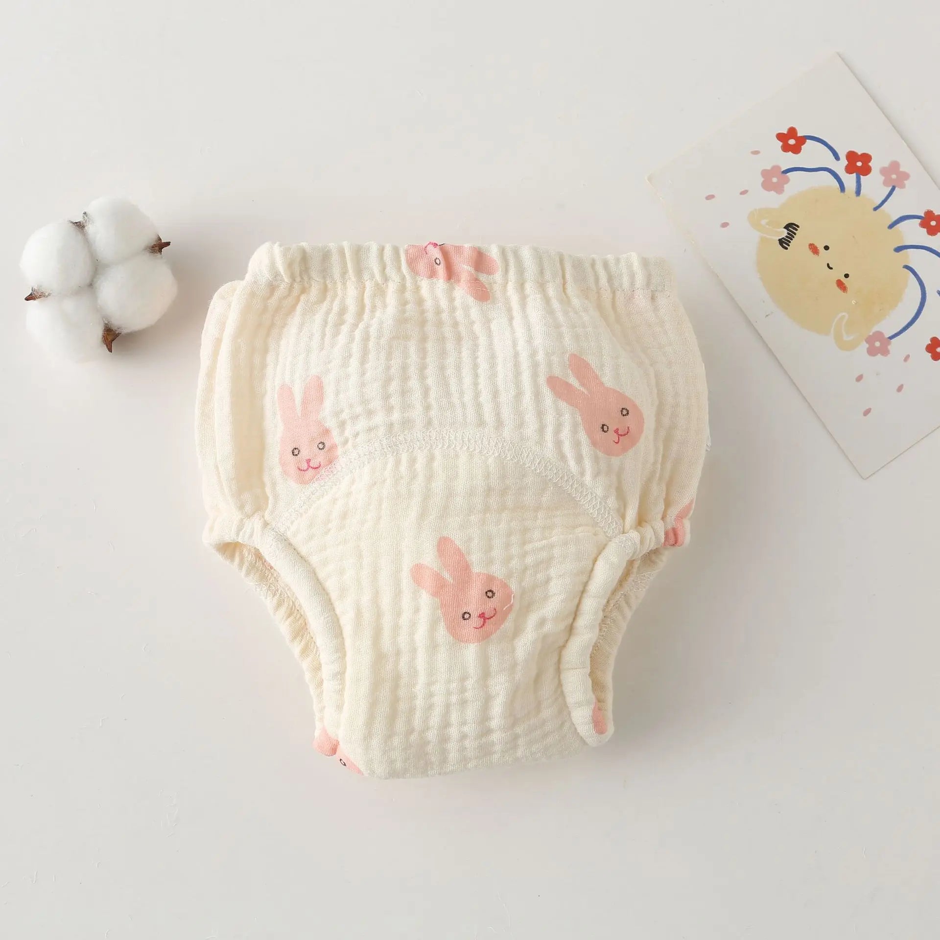 Cotton muslin baby training diaper with cute pink bunny print, soft absorbent baby care underwear.