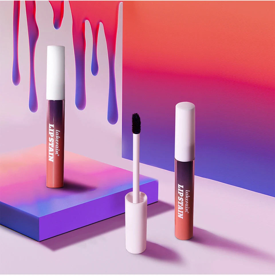 Waterproof peel-off pink lip stain tubes and applicator on a vibrant gradient background. Long-lasting, transfer-proof.