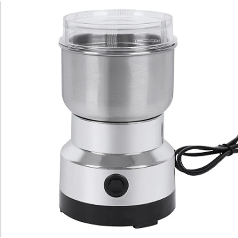 Compact stainless steel electric coffee bean grinder with clear lid and single-button operation on a black base.