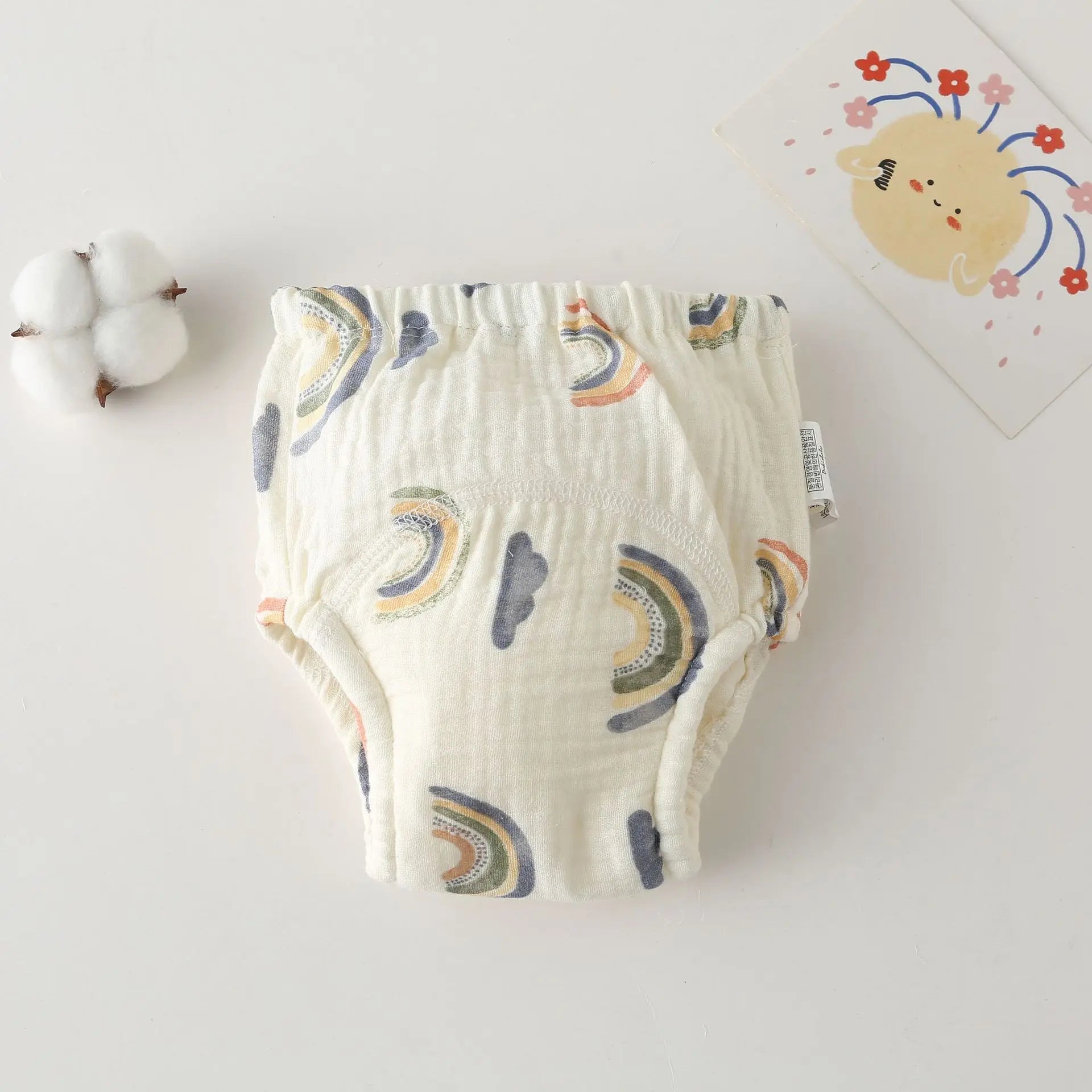 Cotton baby potty training diaper with rainbow and cloud print, breathable muslin fabric for infant care.