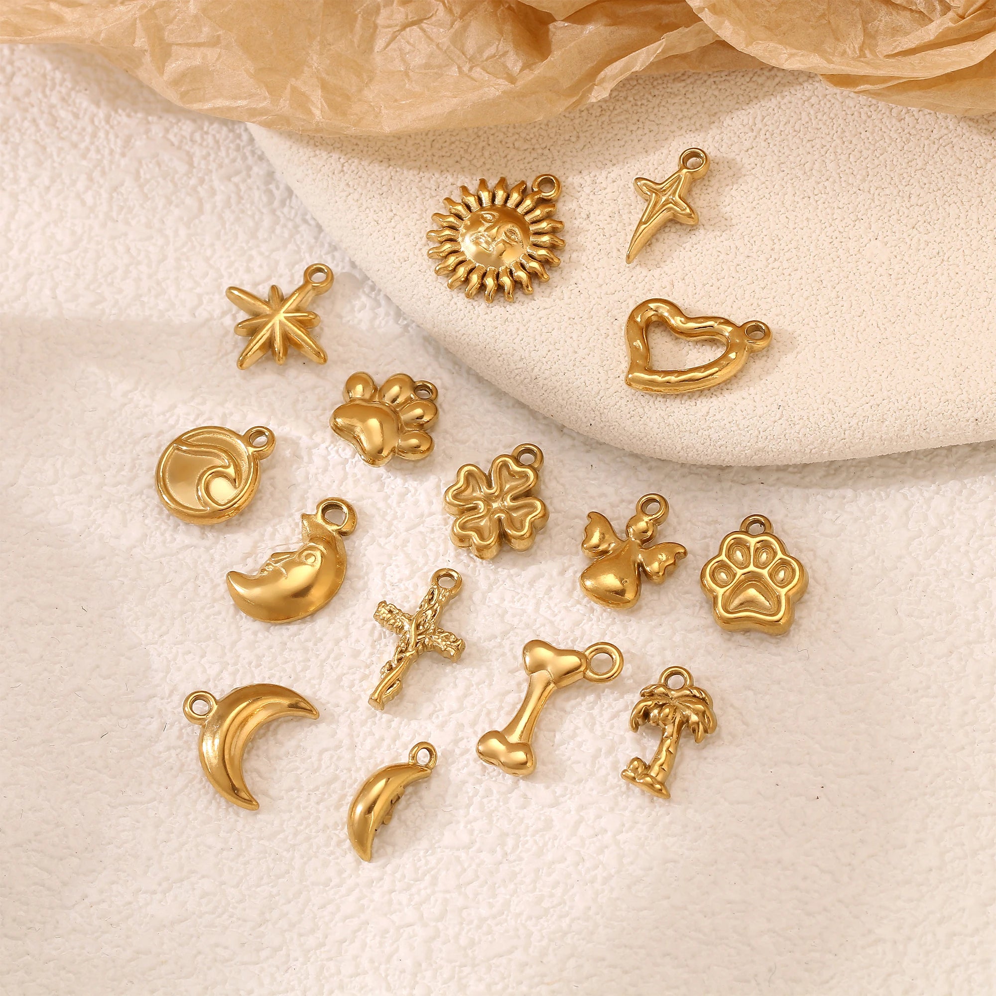 Gold stainless steel small charms featuring pet paw prints, stars, and waves for DIY jewelry making and pet accessories.