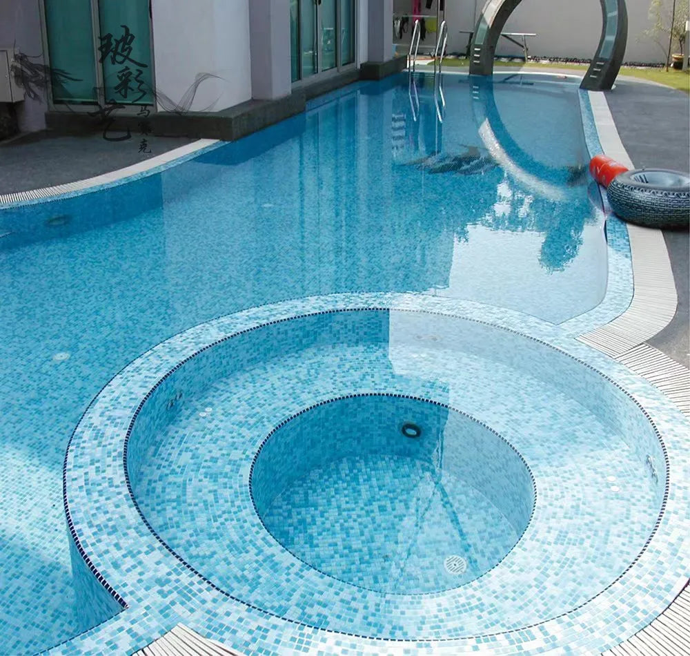 Ceramic mosaic pool tiles in blue square pattern for circular pool floor edging.