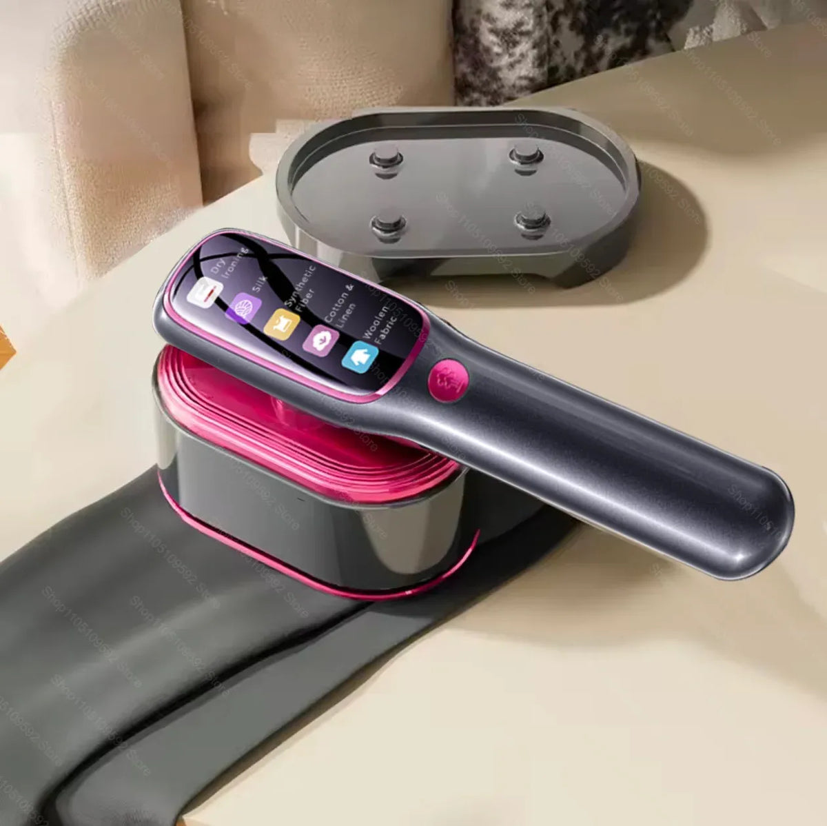 Handheld garment steamer with digital display rests on its base next to a silicone ironing pad.