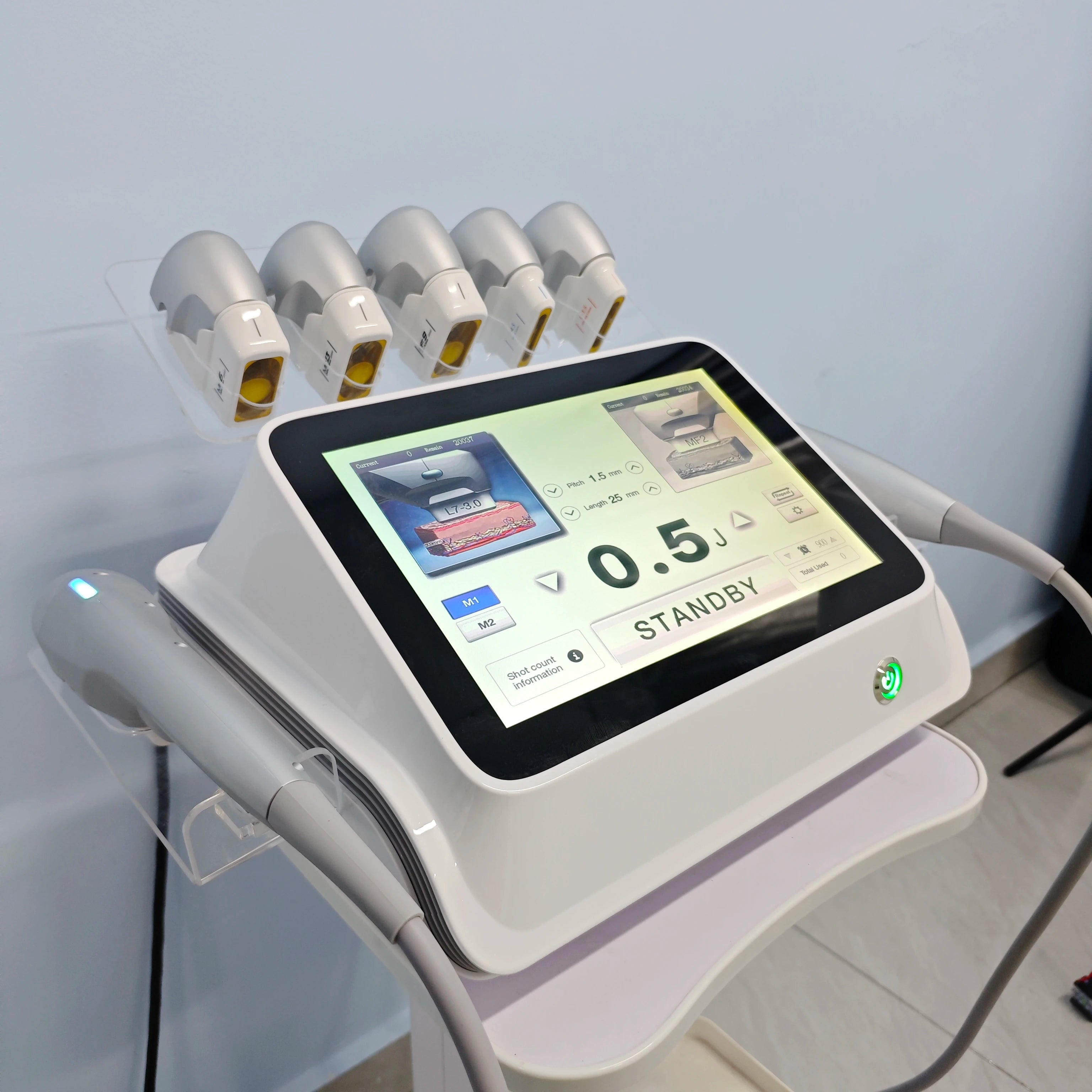 White 7D beauty machine with a digital touchscreen display, multiple handpieces, and five attached probe tips.