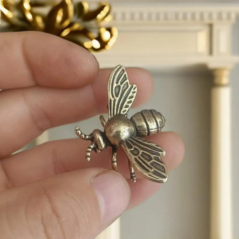 Small solid brass bee tea pet figurine, detailed golden metal bee sculpture for home or desktop decor.