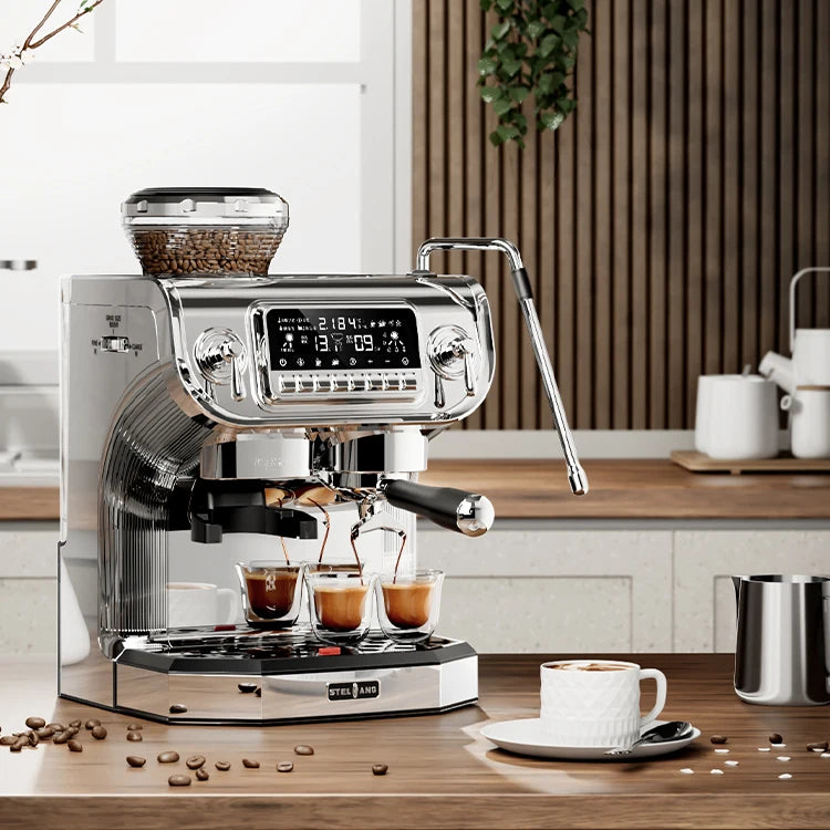 Stelang chrome espresso machine with digital display, bean hopper, and steam wand brewing three shots on wood counter.