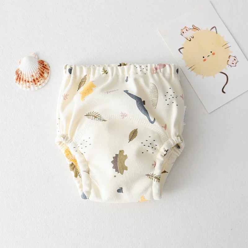 Baby training diaper with cream dinosaur and leaf print, reusable cloth baby care underwear.