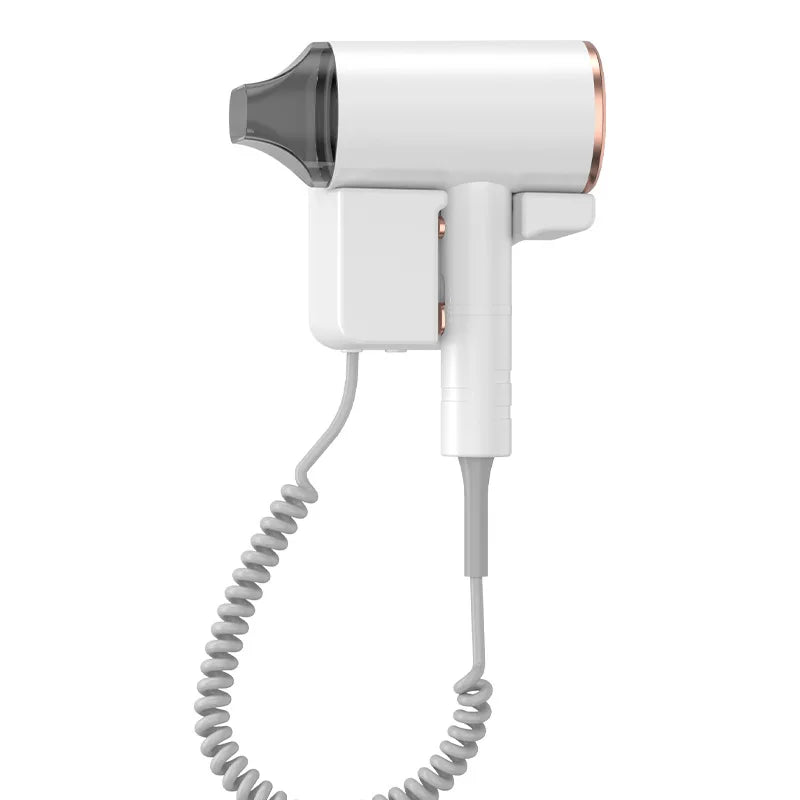White wall-mounted hotel hair dryer with rose gold accents, nozzle attachment, and coiled cord for bathroom styling.