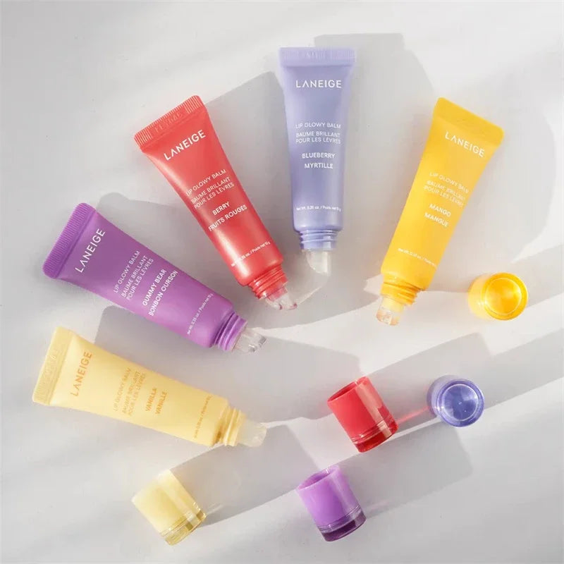 Laneige Lip Glowy Balm set in Berry, Blueberry, Mango, Gummy Bear, and Vanilla tubes for hydrated, plumping lip care.