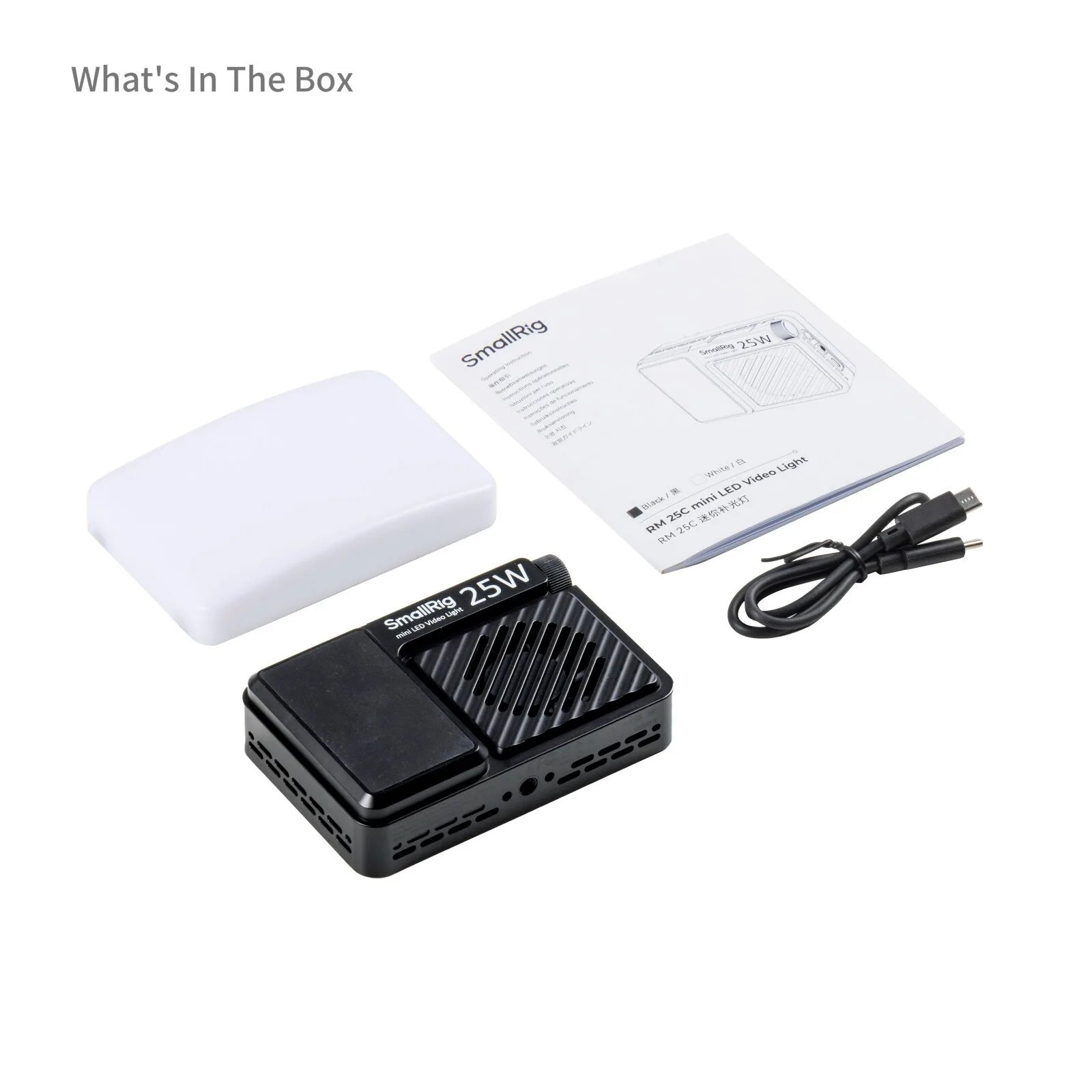 Mini LED video light with white diffuser, instruction manual, and charging cable on a white background.