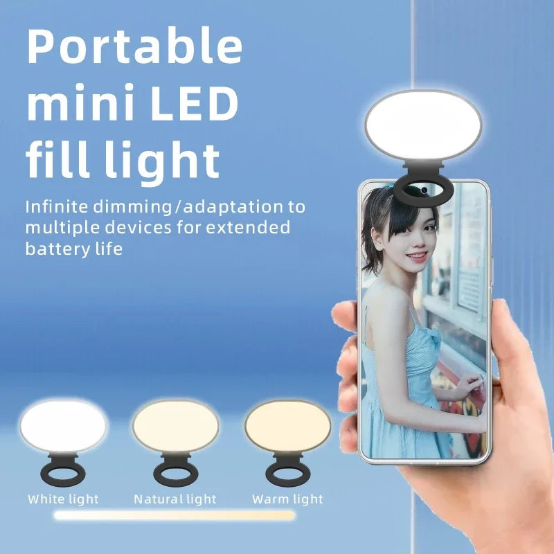 Small, oval LED clip-on fill light for smartphones, featuring adjustable white, natural, and warm light settings.