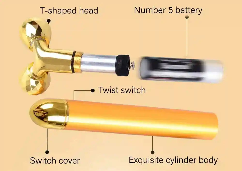 Disassembled gold facial massager with T-shaped roller head, cylindrical body, and AA battery with labels.