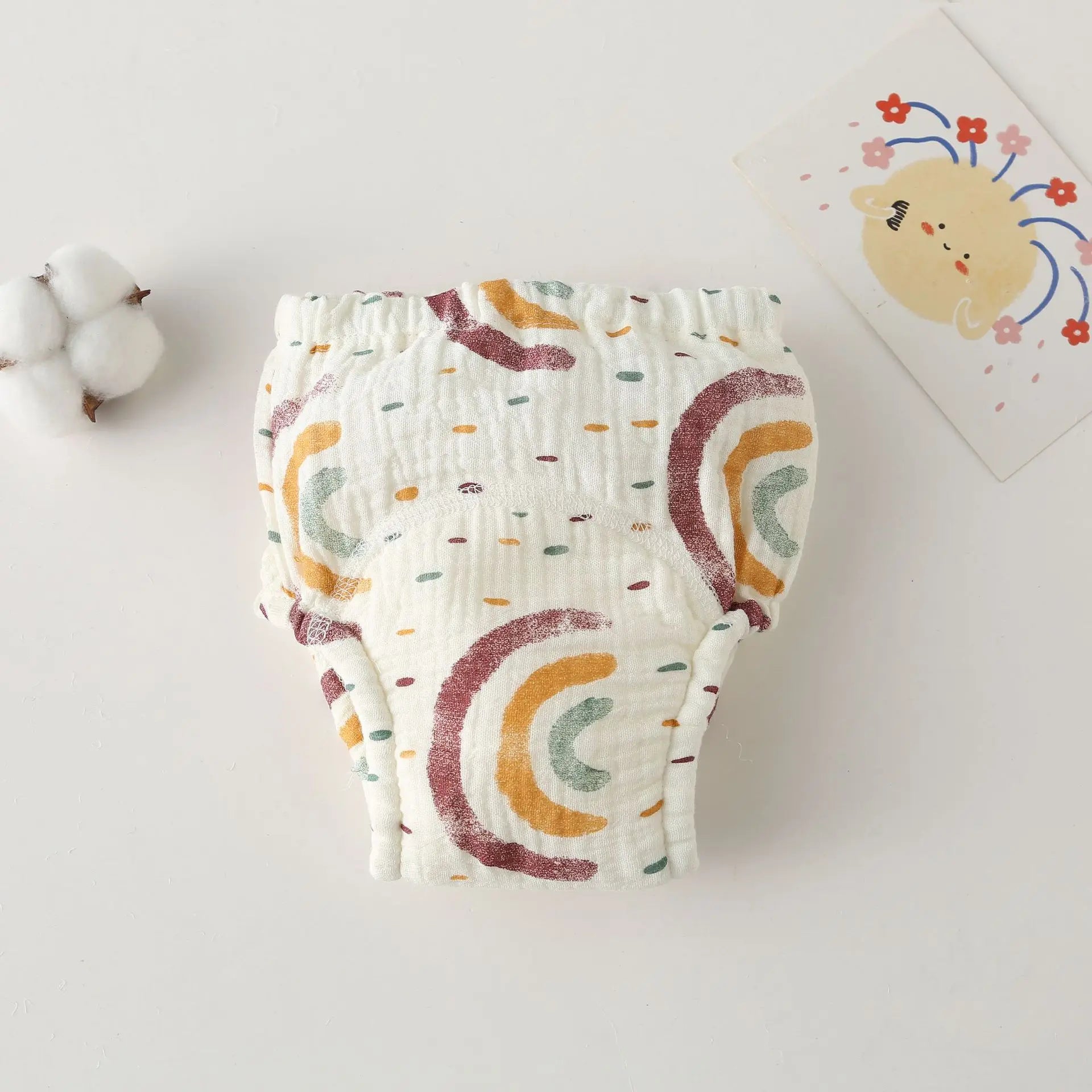Cotton muslin baby training diaper with rainbow print, breathable baby care essential for potty training.