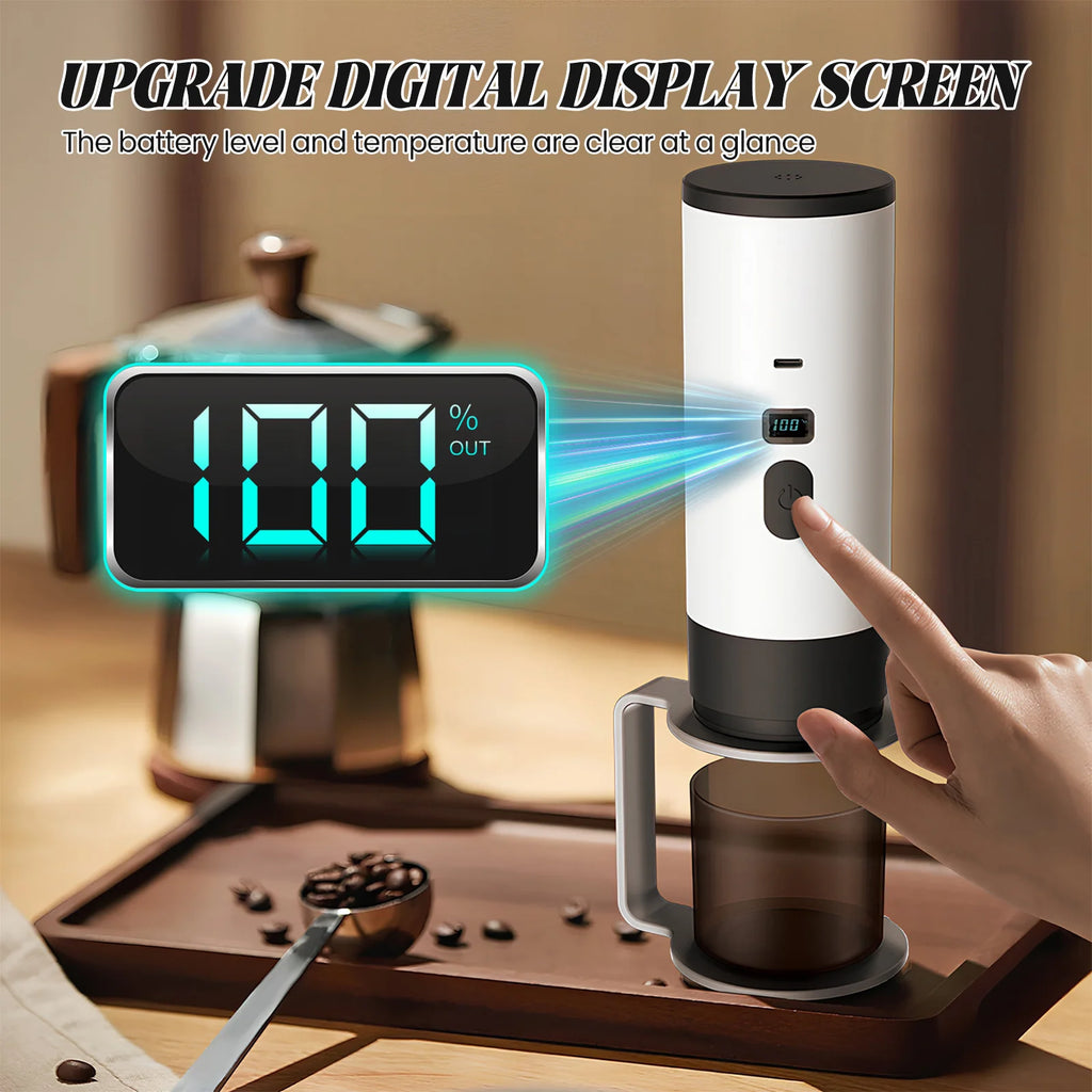 Portable white digital electric coffee maker with LED display showing battery level and temperature on a wooden tray.