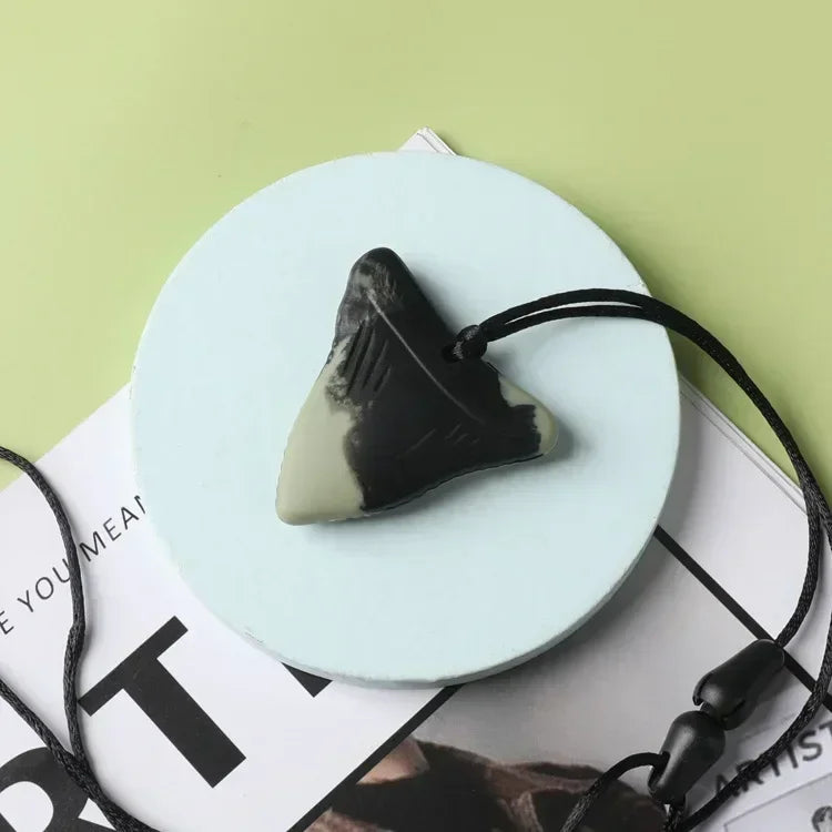 Black and grey silicone teething toy for baby teething relief.