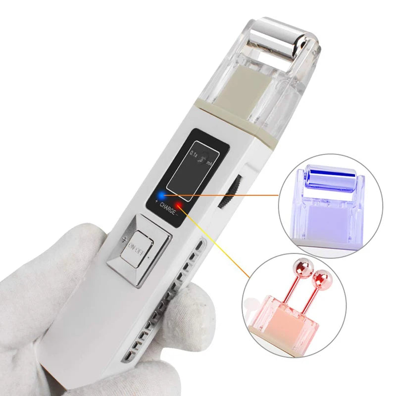 White handheld galvanic microcurrent facial device with a digital display, interchangeable roller and ball heads.