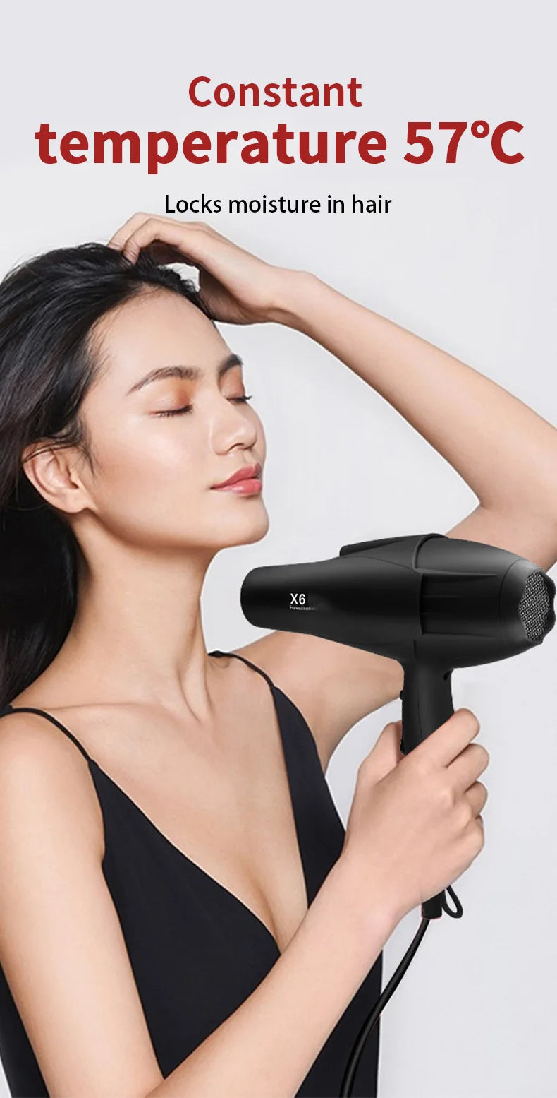 Woman using black X6 professional 2400W hair dryer with constant 57°C temperature control for salon-quality results.
