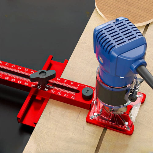 Router circle cutting jig with blue router and red aluminum base, set on wood board