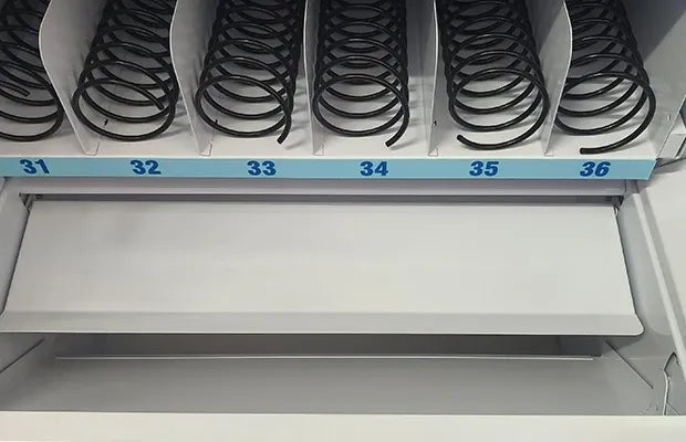 Vending machine spiral coil compartment with numbered slots 31 to 36