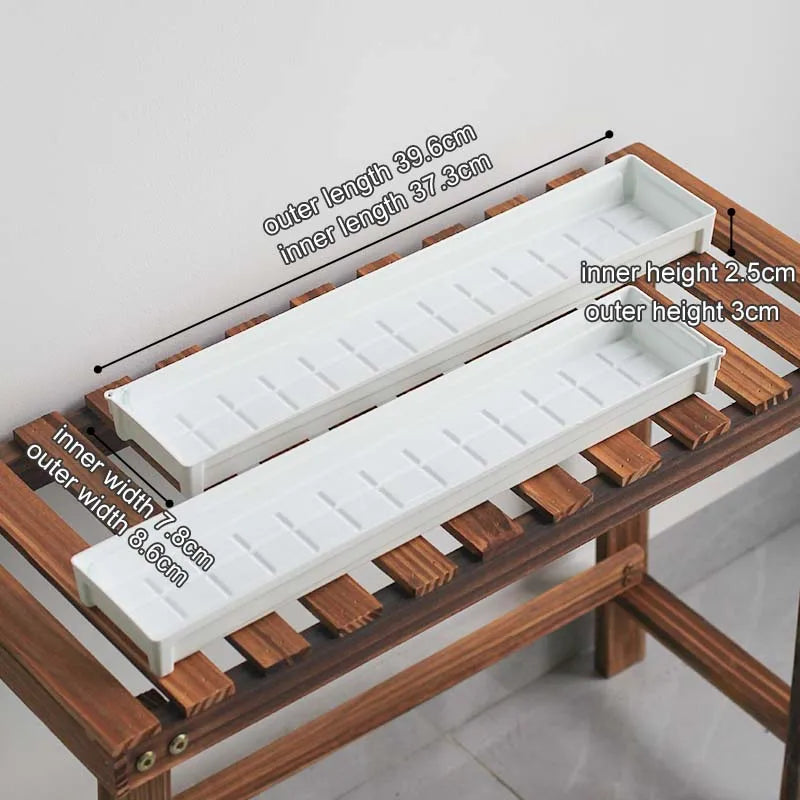 White rectangular drainage tray with grid surface and raised edges for plant pot drainage