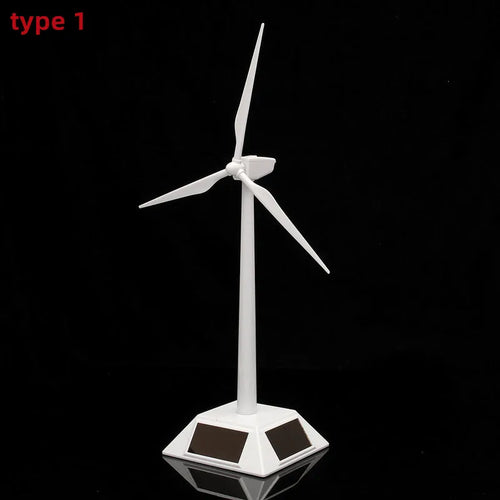 Small white desktop wind turbine model with solar panels on its square base, isolated against a black background.
