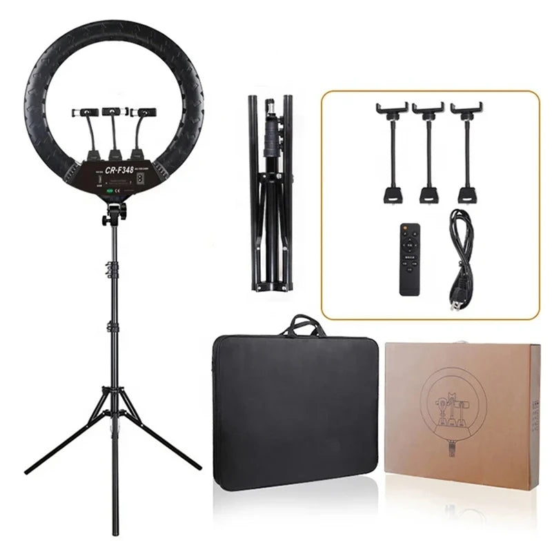 Black circular LED ring light with tripod stand, three phone mounts, remote control, power cord, and carrying case.