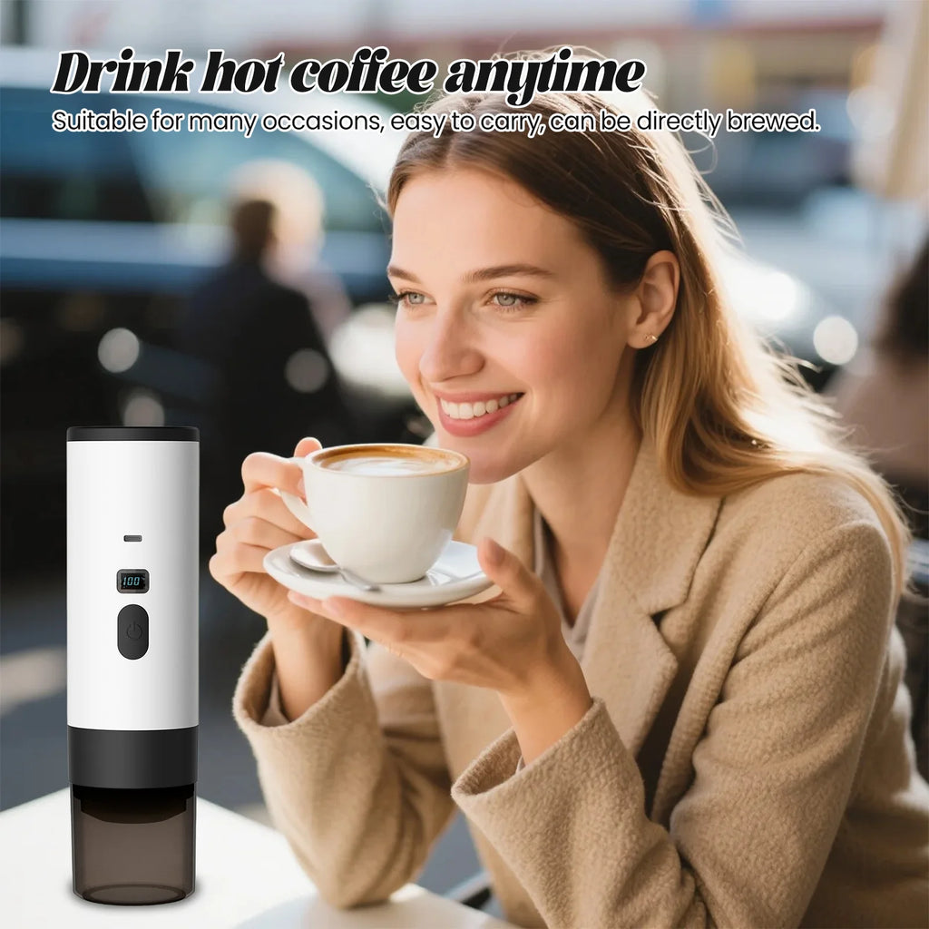 Portable white electric coffee maker with digital temperature display next to a woman drinking coffee at a cafe.