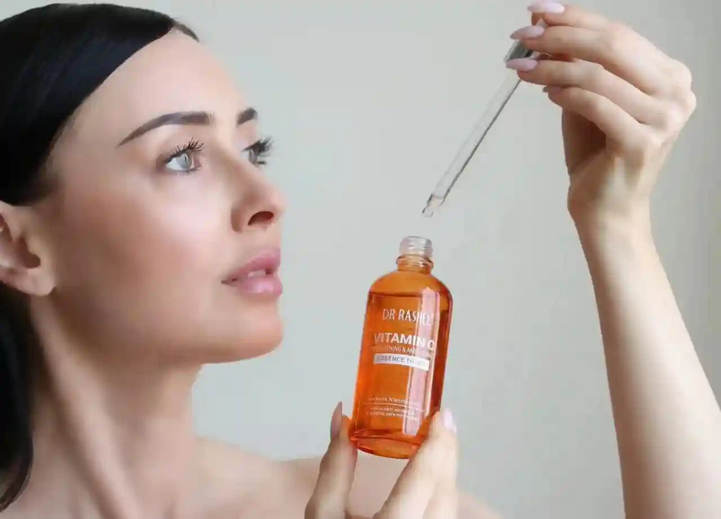 Dr. Rashel Vitamin C Essence Toner in an orange glass dropper bottle for skin brightening, moisturizing, and anti-aging.