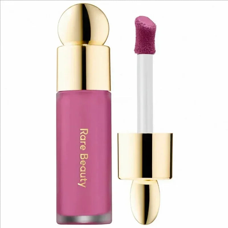 Rare Beauty matte liquid lipstick in rich berry pink with gold cap and smooth applicator. Comfortable, moist lip makeup.