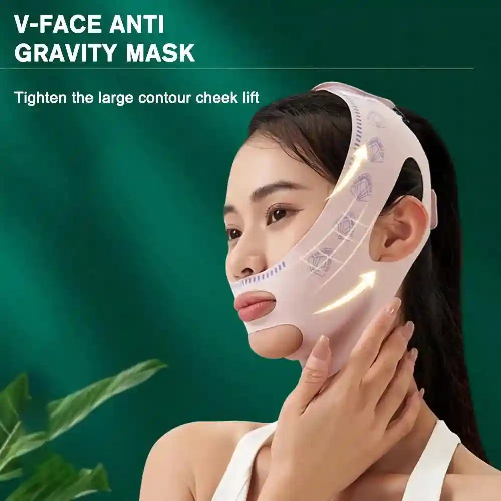 A woman wears a light pink, fabric V-line lifting strap over her chin and cheeks against a green background.