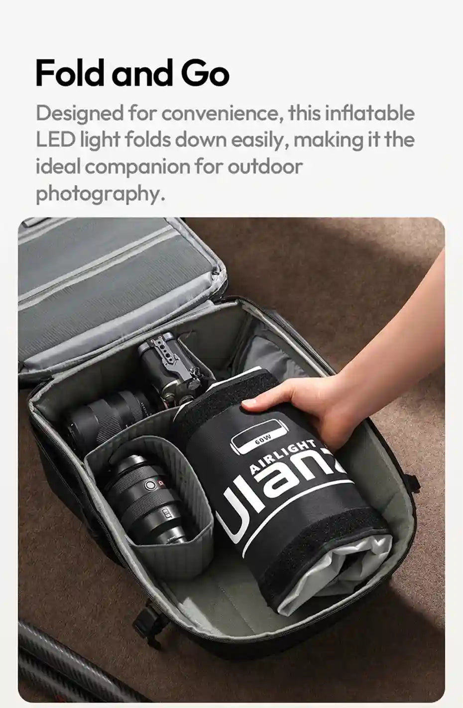 A black, cylindrical, inflatable LED light being packed into a camera bag for portable photography lighting.