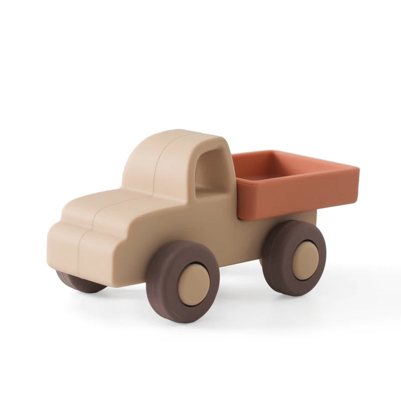 Beige and brown silicone baby teething toy truck for soothing sore gums.