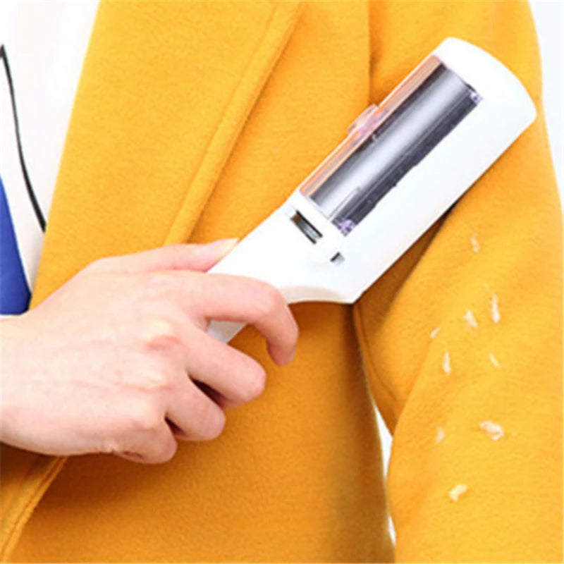 White self-cleaning electrostatic lint remover brush removes dog and cat hair from a yellow coat.