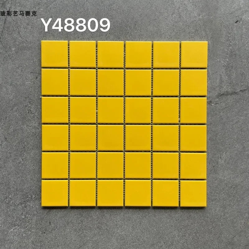 Yellow ceramic mosaic tile sheet with small square tiles and black grout lines