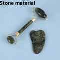 A green natural stone facial roller and a heart-shaped gua sha massage tool on a light blue background.