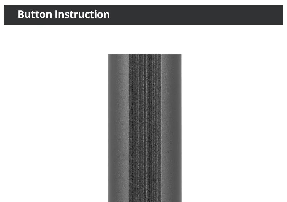 Close-up of a matte dark gray cylindrical metal button with vertical ridged texture for tactile grip.