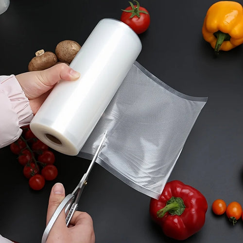 Vacuum seal bag roll with cutter and silver sheet, shown with fresh produce