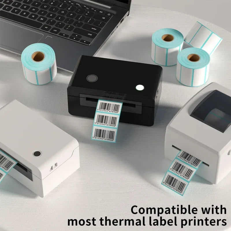 White barcode label rolls with light-blue accents and printed shipping labels on devices